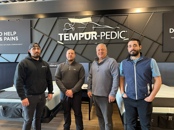 Aitoro Family poses in their new Norwalk mattress showroom