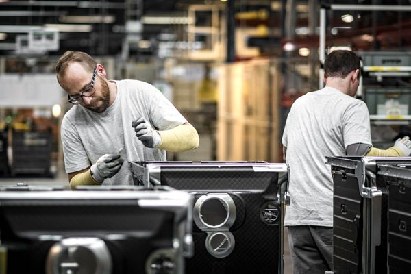 iStock Credit: vm Factory workers assembling washers
