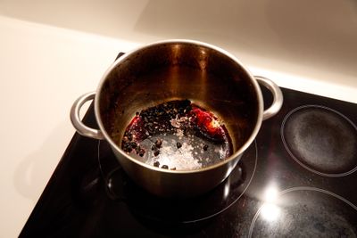An overhead view of a burnt pot on an electric cooktop