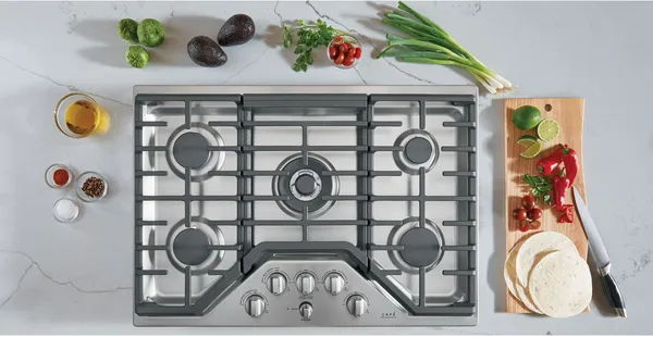 An overhead view of the Cafe CGP95302MS1 cooktop with produce