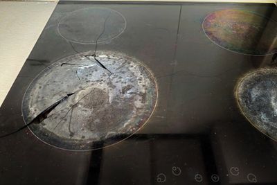 A close-up of a cracked electric cooktop 