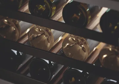 A close-up of bottles inside the Fisher & Paykel Series 9 RS2435V2RT1 wine cooler 