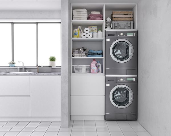 A gray stacked washer and dryer set in a laundry room 