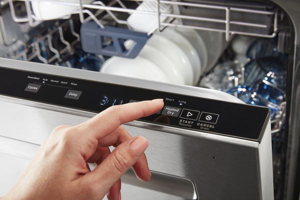 A person selecting the Heated Dry cycle on the Maytag MDB8959SKZ dishwasher 