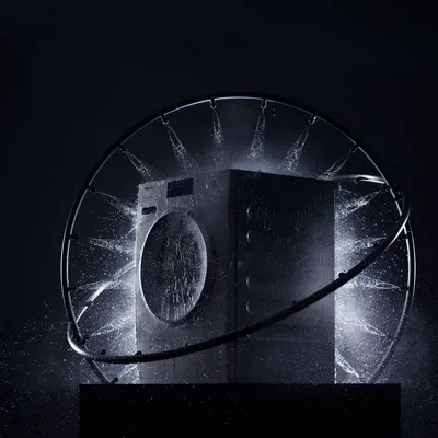 A Miele washer inside a water ring shown against a black background 