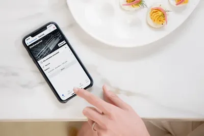 A woman using the Home Connect app on a smart device 