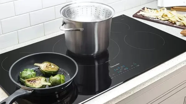 The Thermador Masterpiece CIT365YB cooktop featuring sauteing artichokes 