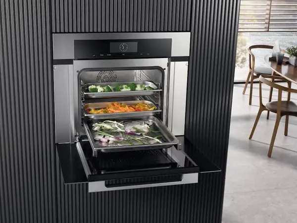 An overhead view of vegetables cooking inside a Miele steam oven