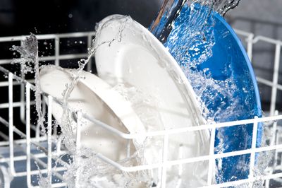 A close-up of water spraying dishes in a dishwasher 