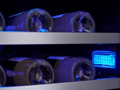 A close-up of bottles inside the Zephyr Presrv PRW24C02AG-ADA wine cooler 