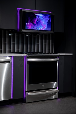 A campaign image of the GE Profile PHS930YPFS range with purple LED lighting 