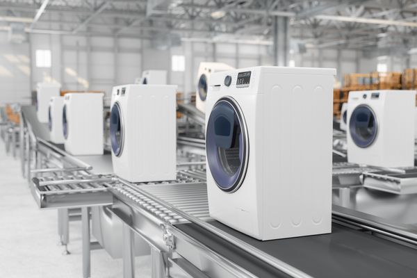A factory assembly line featuring front load washers