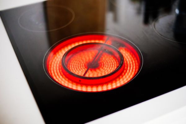 A close-up of a radiant cooktop glowing 