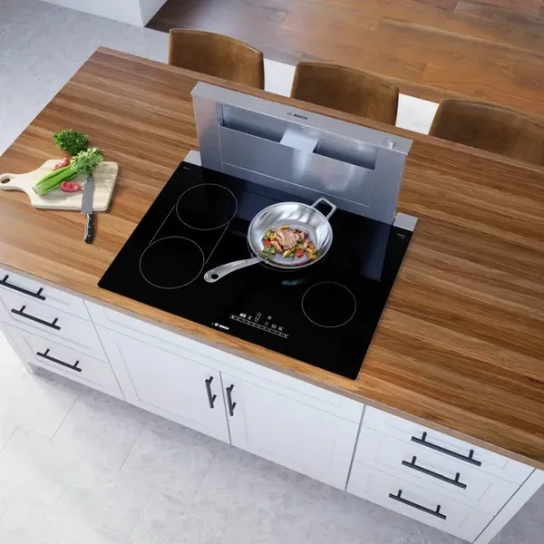 Overhead view of the Bosch 800 Series NET8069UC cooktop cooking