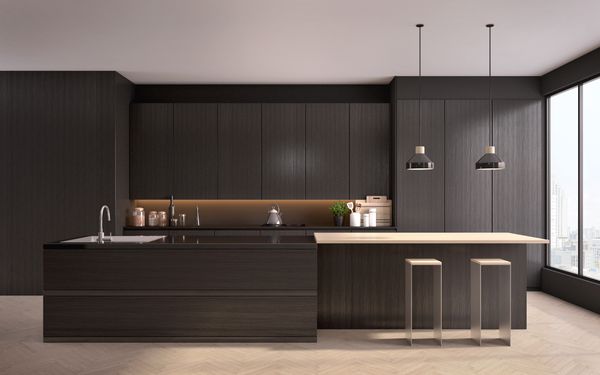 A wide shot of a minimalist kitchen with dark wood finishes 