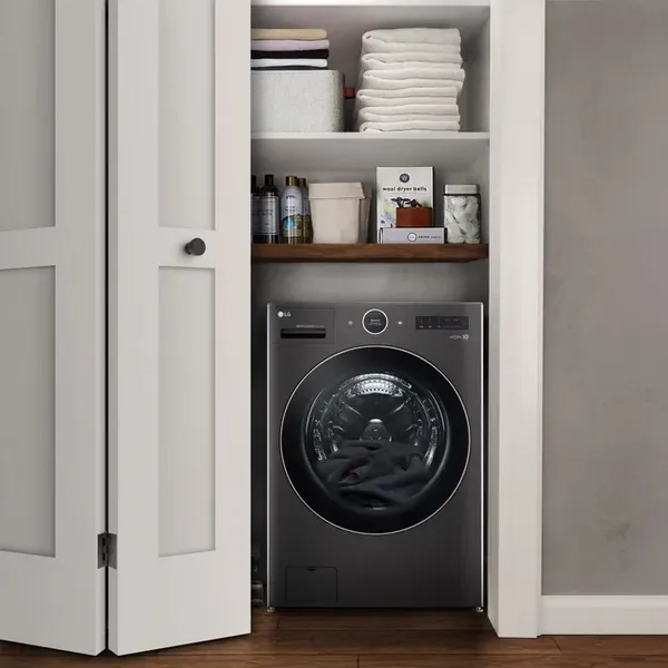 The LG WM6998HBA washer dryer combo in a laundry closet 