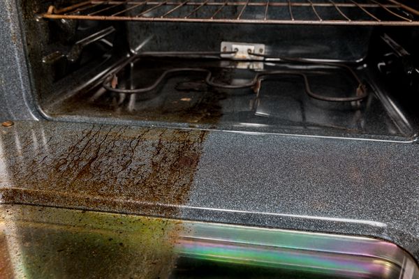 A side by side of a cleaned and uncleaned oven surface