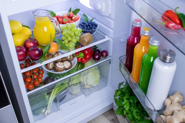 A refrigerator stocked with fruits and vegetables 