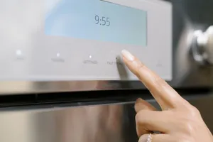 A close-up of a person using the Thermador Professional POW02W oven control panel