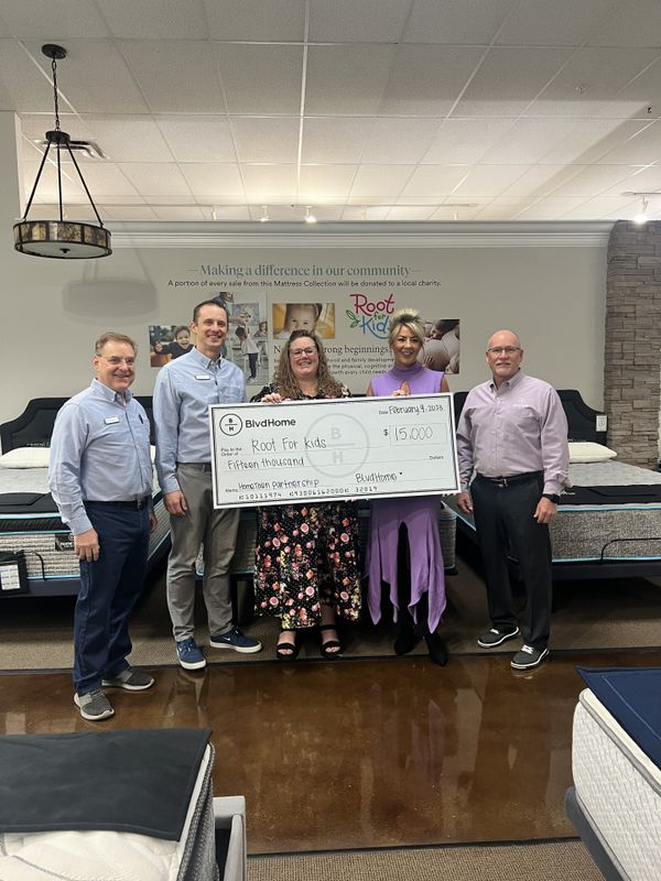 BlvdHome team presenting check for Roots for Kids