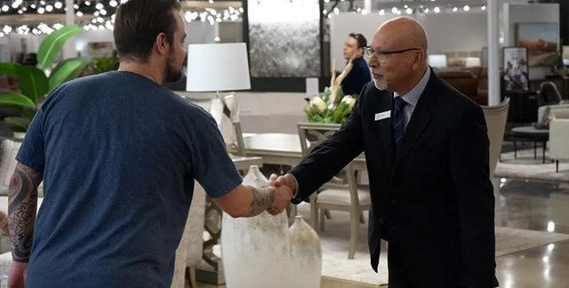 view of a blvdhome employee shaking the hand of a person entering the store