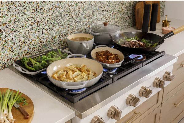A close-up of the Cafe CGU366P2TS1 rangetop with entrees