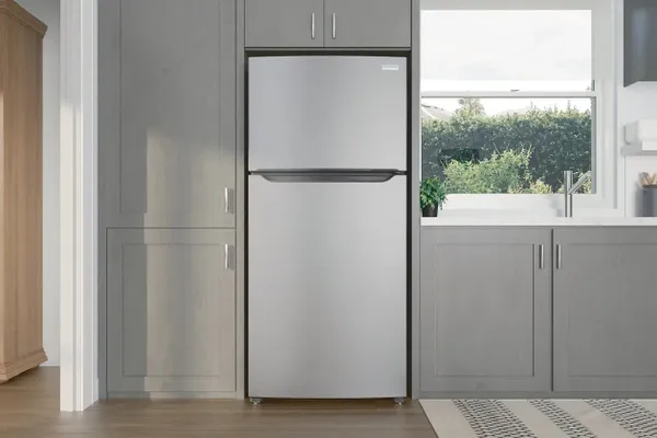 The Frigidaire FFHT2045VS refrigerator installed between cabinets 