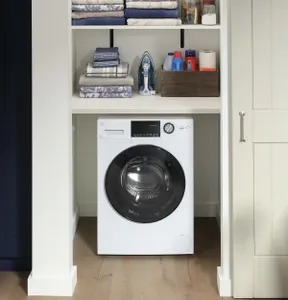 The GE GFQ14ESSNWW washer dryer combo in a closet 
