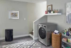 The LG WM6998HVA washer dryer combo in a laundry room 
