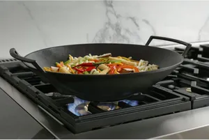 A close-up of the Monogram ZGU486NDTSS rangetop with a wok