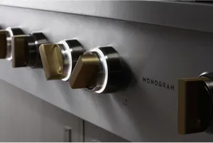 A close-up of the Monogram ZGU486NDTSS rangetop knobs