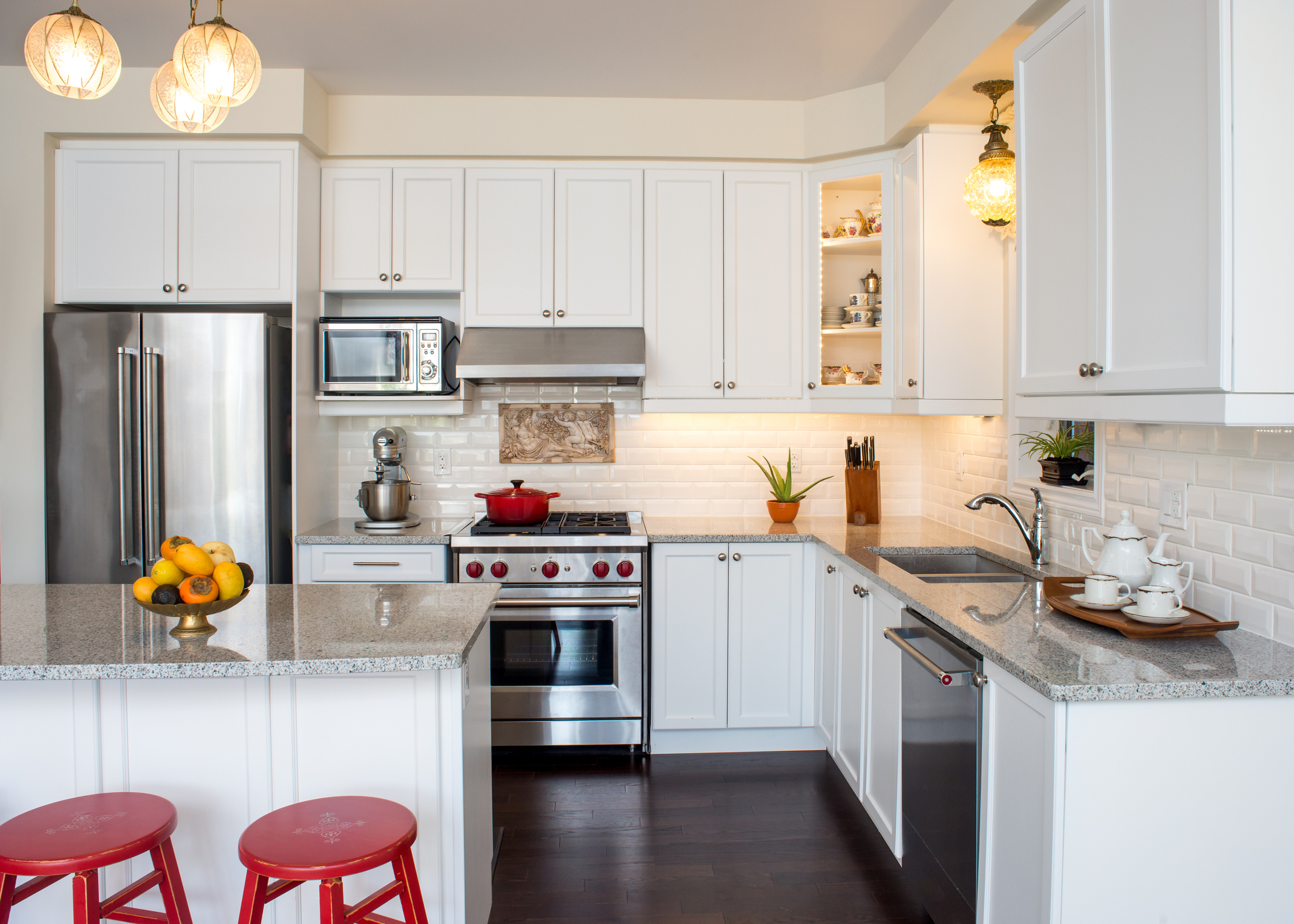 mall white kitchen with compact stainless steel appliances