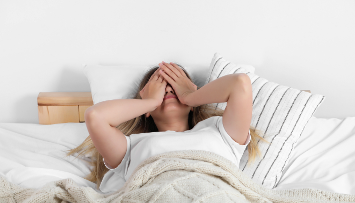woman laying awake in bed
