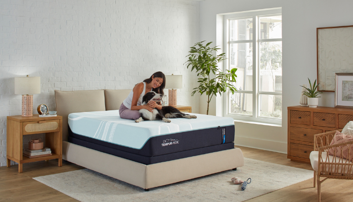 woman and dog enjoying a tempur-adapt mattress