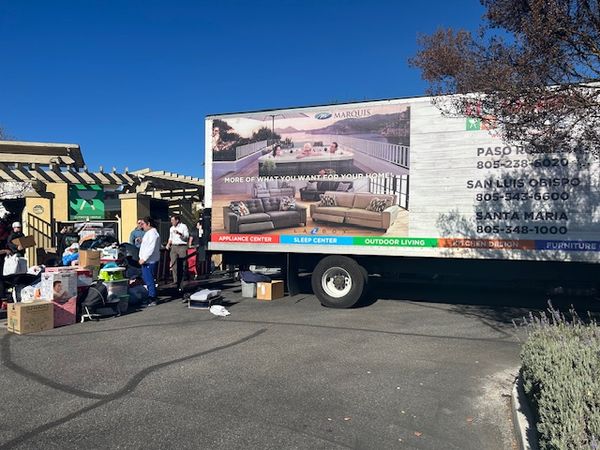 Volunteers work to load donations onto a delivery truck