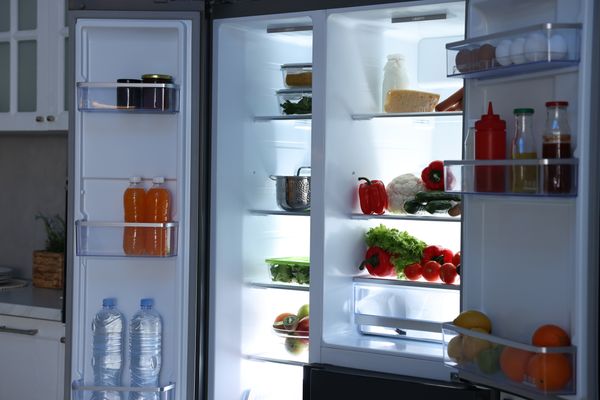An open refrigerator with a variety of foods 