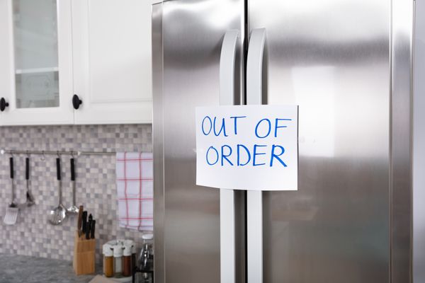 An out of order sticky note on a refrigerator 