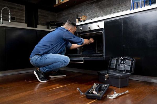 Man repairing an oven