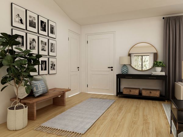 Entry way decorated with a bench, photo wall, and decorative entry way table