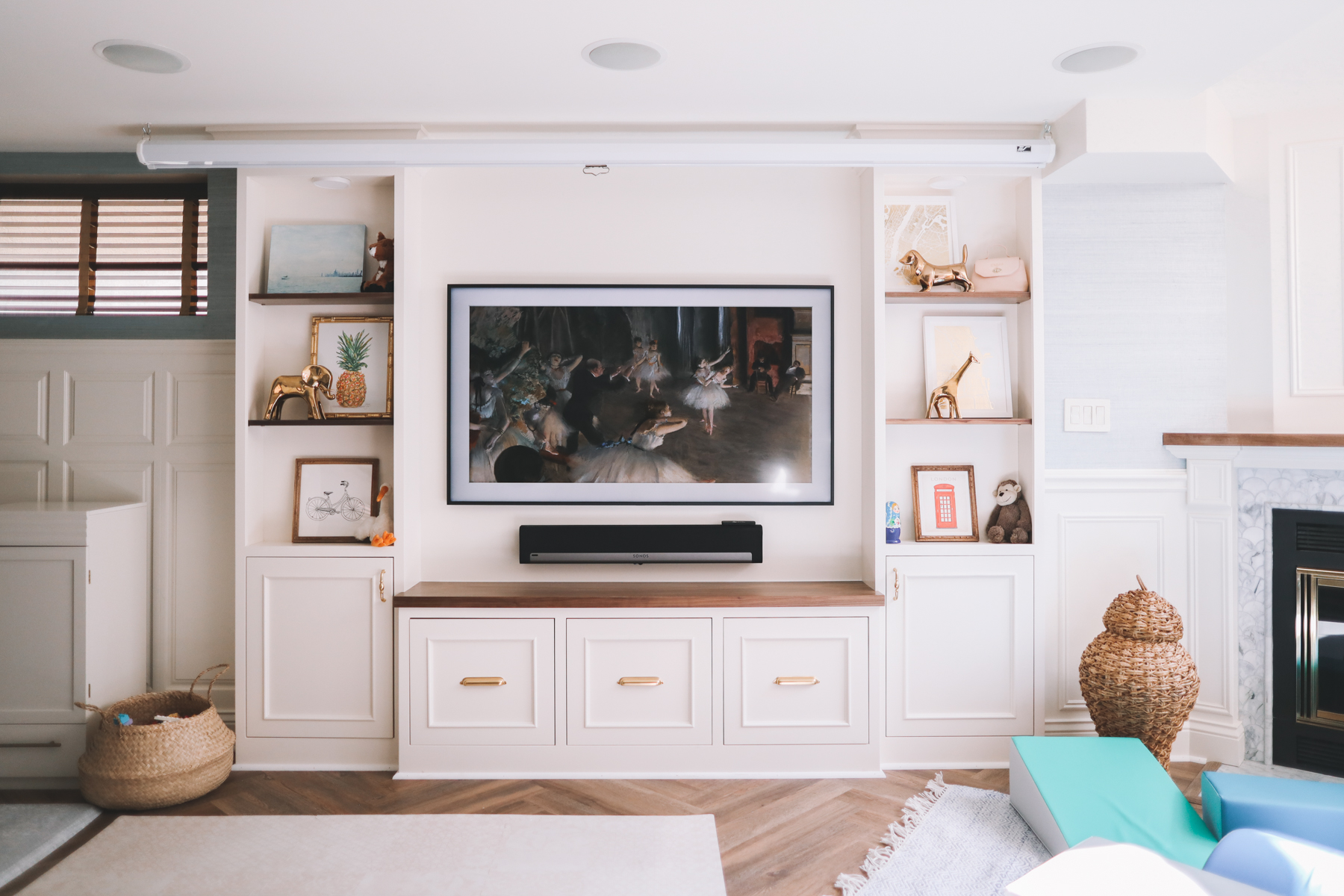 Living room with white cabinets and a frame television