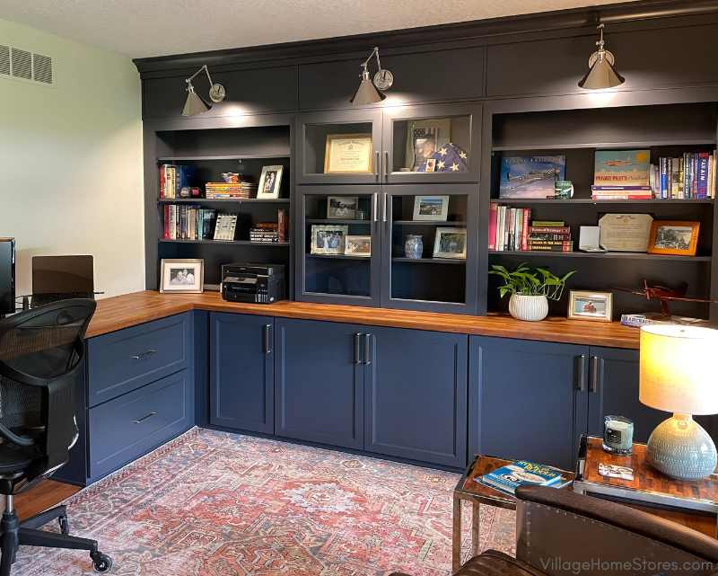 image of home office base and wall cabinets with bookshelves, storage, wood tops, and space for sconce lighting. Charcoal Blue painted Koch Cabinetry by Village Home Stores.