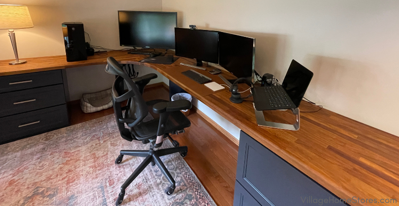 Wood desk top in home office with blue cabinets