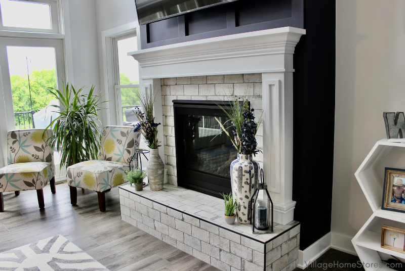 Image of tiled fireplace surround on black accent wall.