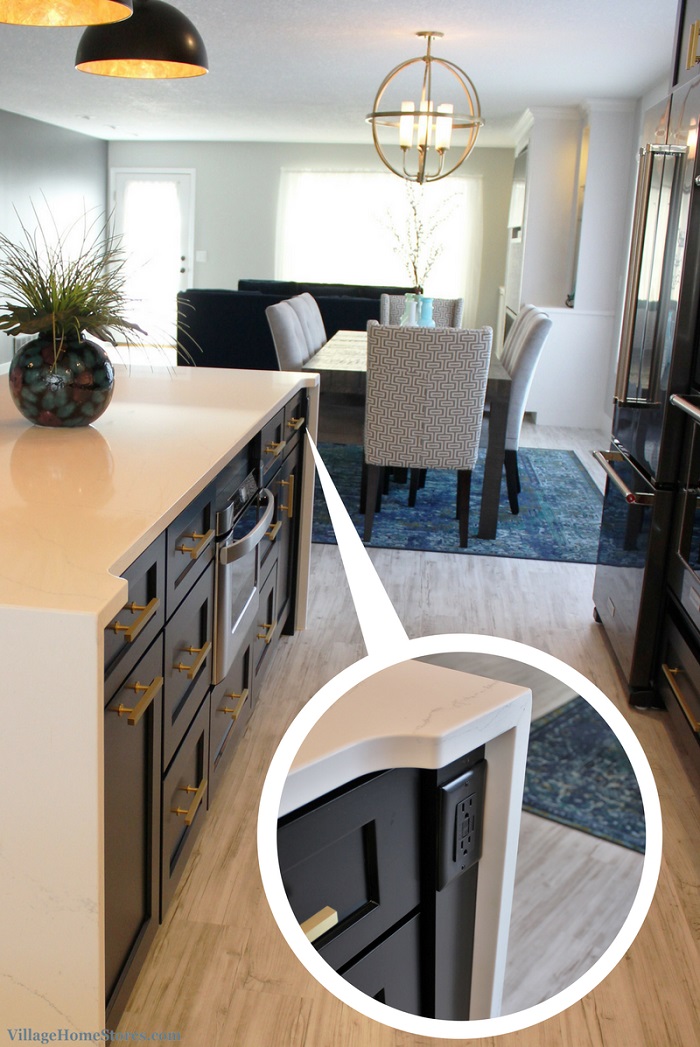 Black cabinet Island end post detail for hidden black outlet concealed within waterfalling countertops
