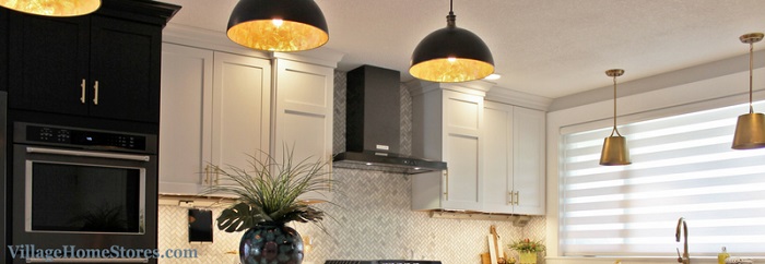 image of kitchen lighting with black dome pendants and gold interior plus brushed gold pendants at the kitchen sink window