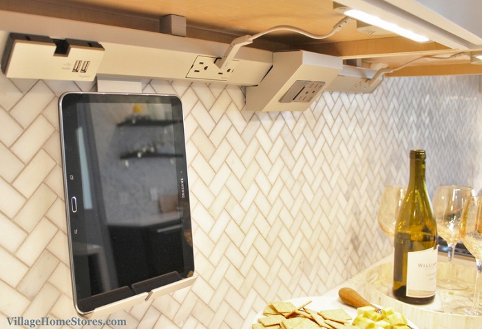close up of legrand modular undercabinet lighting system with moveable outlets, charging docs, and speakers