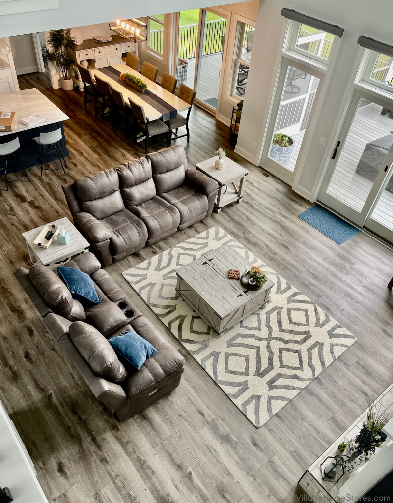 birdseye view of vinyl plank gray wood look flooring in a great room with furniture. Luxury vinyl plank is RigidCORE Keystone XL in Warm Gray color. 