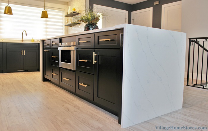 image of black cabinet kitchen island with waterfalling white quartz countertop surfaces on top and side