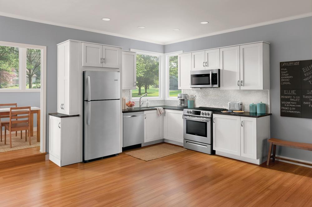 Frigidaire top-freezer refrigerator in a sunlit kitchen