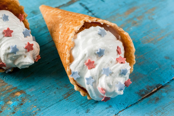 Homemade ice cream in waffle cone, decorated with stars in traditional colors.